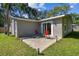 Exterior view of backyard featuring a cozy patio with red chairs at 503 Tangerine Dr, Oldsmar, FL 34677