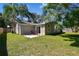 Spacious backyard featuring a concrete patio with chairs at 503 Tangerine Dr, Oldsmar, FL 34677