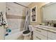 Modern bathroom featuring a marble tiled shower, white vanity with marble countertop, and a built-in shelving unit at 503 Tangerine Dr, Oldsmar, FL 34677
