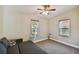 Cozy bedroom featuring natural light from two windows and a ceiling fan at 503 Tangerine Dr, Oldsmar, FL 34677