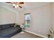 Well-lit bedroom featuring neutral walls, ceiling fan, and a view of outside through the windows at 503 Tangerine Dr, Oldsmar, FL 34677
