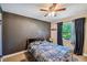 This cozy bedroom has a contrasting black wall and a sunlit window at 503 Tangerine Dr, Oldsmar, FL 34677