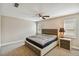 A cozy bedroom with a modern ceiling fan and neutral color scheme at 503 Tangerine Dr, Oldsmar, FL 34677