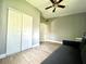 Bedroom features a closet with sliding doors, modern flooring, and neutral paint at 503 Tangerine Dr, Oldsmar, FL 34677
