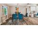 Bright dining area featuring a glass table, blue chairs, and wood-look floors at 503 Tangerine Dr, Oldsmar, FL 34677