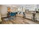 Open-concept dining and kitchen area featuring modern wood floors and blue chairs at 503 Tangerine Dr, Oldsmar, FL 34677