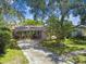 Charming single-Gathering home with mature trees, landscaping, and a long driveway at 503 Tangerine Dr, Oldsmar, FL 34677