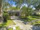 Charming single-Gathering home with mature trees, landscaping, and a long driveway at 503 Tangerine Dr, Oldsmar, FL 34677