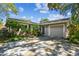 Charming home featuring a well-kept lawn, mature landscaping, and a one-car garage, creating inviting curb appeal at 503 Tangerine Dr, Oldsmar, FL 34677