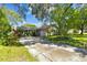 Single-story home with beautiful landscaping, a long driveway, and a well-maintained lawn at 503 Tangerine Dr, Oldsmar, FL 34677