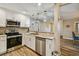 Updated kitchen with granite counters, stainless appliances, and wood-look floors at 503 Tangerine Dr, Oldsmar, FL 34677