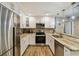 Modern kitchen with stainless steel appliances and stunning marble countertops at 503 Tangerine Dr, Oldsmar, FL 34677