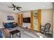 Bright living room with a ceiling fan, wood floors, and eye-catching yellow curtains at 503 Tangerine Dr, Oldsmar, FL 34677