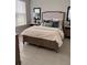 Comfortable bedroom with neutral walls, a large bed with stylish linens, and bedside tables at 5406 Rushmere Ct, Palmetto, FL 34221