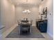 The dining room has a modern chandelier, seating for six, and stylish decor at 5406 Rushmere Ct, Palmetto, FL 34221