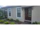 Inviting front entrance with a mahogany front door, manicured landscaping, and sidelight windows at 5406 Rushmere Ct, Palmetto, FL 34221
