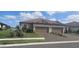 Charming home with two-car garage, landscaped lawn, and brick driveway on a sunny day at 5406 Rushmere Ct, Palmetto, FL 34221