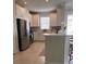 Modern kitchen featuring stainless steel appliances, white cabinets, and a functional center island at 5406 Rushmere Ct, Palmetto, FL 34221