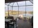 Enclosed lanai overlooking a serene pond, offering outdoor seating and beautiful views at 5406 Rushmere Ct, Palmetto, FL 34221