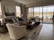 Bright and airy living room with comfortable seating, tile floors, and expansive lake views at 5406 Rushmere Ct, Palmetto, FL 34221