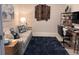 Cozy home office with a comfortable couch, dark blue rug, and modern desk at 5406 Rushmere Ct, Palmetto, FL 34221