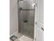 Contemporary shower with glass door, neutral tile, and built-in shelving for bath products at 5406 Rushmere Ct, Palmetto, FL 34221