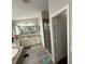 Bright bathroom featuring a double sink vanity, shower, and tile floors at 5554 Riva Ridge Dr, Wesley Chapel, FL 33544