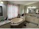 Luxurious bathroom featuring a soaking tub, dual sinks, and elegant vanity at 5554 Riva Ridge Dr, Wesley Chapel, FL 33544