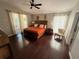 Cozy bedroom with a wooden bed frame and warm, inviting decor at 5554 Riva Ridge Dr, Wesley Chapel, FL 33544