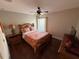 Bright bedroom with a wooden bed frame, patterned bedding, and natural lighting at 5554 Riva Ridge Dr, Wesley Chapel, FL 33544