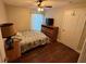 Cozy bedroom featuring a comfortable bed, dresser, closet, and natural lighting at 5554 Riva Ridge Dr, Wesley Chapel, FL 33544