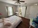 Cozy bedroom with a full bed, dark wood floors, and natural light at 5554 Riva Ridge Dr, Wesley Chapel, FL 33544