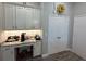 Butler Pantry featuring white cabinetry, counter space, coffee bar, and storage space at 5554 Riva Ridge Dr, Wesley Chapel, FL 33544