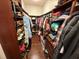 Organized walk-in closet with custom shelving and hanging space for clothes and shoes at 5554 Riva Ridge Dr, Wesley Chapel, FL 33544