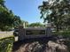 Community center sign surrounded by lush landscaping and mature trees offers a welcoming community at 5554 Riva Ridge Dr, Wesley Chapel, FL 33544
