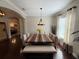 This open dining room features hardwood floors, a chandelier, and a table with a bench at 5554 Riva Ridge Dr, Wesley Chapel, FL 33544