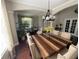 The dining area has a wood table, stylish chandelier, and lots of natural light at 5554 Riva Ridge Dr, Wesley Chapel, FL 33544