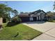 Charming home exterior with a well-manicured lawn, two-car garage and long driveway at 5554 Riva Ridge Dr, Wesley Chapel, FL 33544