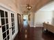 The foyer has French doors, wood floors, and an open concept floor plan at 5554 Riva Ridge Dr, Wesley Chapel, FL 33544
