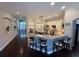 Well-lit kitchen featuring an island with barstools, granite countertops, and stainless steel appliances at 5554 Riva Ridge Dr, Wesley Chapel, FL 33544