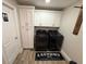 Laundry room with white cabinets and a stacked washer and dryer at 5554 Riva Ridge Dr, Wesley Chapel, FL 33544