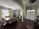 Open-concept living area with elegant lighting, a dining space, and hardwood floors at 5554 Riva Ridge Dr, Wesley Chapel, FL 33544