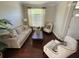 Cozy living room with comfortable sofas, a large window, and hardwood floors at 5554 Riva Ridge Dr, Wesley Chapel, FL 33544