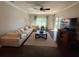 Spacious living room with dark wood floors and a large sectional sofa, perfect for relaxation at 5554 Riva Ridge Dr, Wesley Chapel, FL 33544