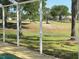 Scenic view from the pool area, overlooking a beautifully landscaped yard and distant golf course at 5554 Riva Ridge Dr, Wesley Chapel, FL 33544