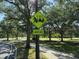 Street View showing community crossing ahead with golf cart and pedestrian at 5554 Riva Ridge Dr, Wesley Chapel, FL 33544