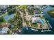 Scenic aerial view of community showing tennis courts, pool, clubhouse, and boat docks along the waterways at 5712 Biscayne Ct # 205, New Port Richey, FL 34652