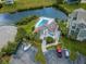 Aerial view showcasing the community pool, nearby parking, and the scenic waterfront at 5712 Biscayne Ct # 205, New Port Richey, FL 34652
