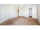 Spacious bedroom with ceiling fan, neutral carpet, and closet space at 5712 Biscayne Ct # 205, New Port Richey, FL 34652