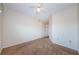 A carpeted bedroom features a ceiling fan and a closet with white folding doors at 5712 Biscayne Ct # 205, New Port Richey, FL 34652